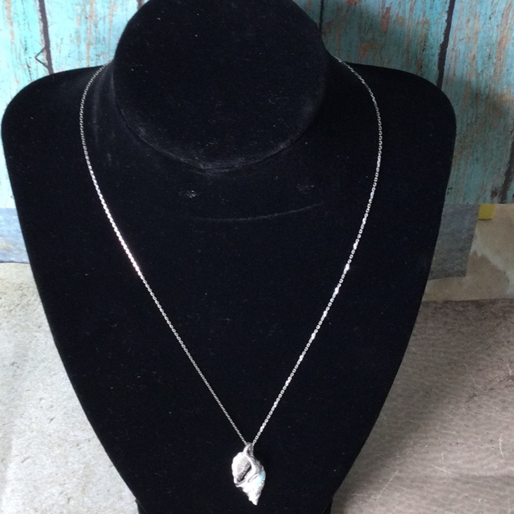 Pretty seashell pendant. Sterling silver on 18” chain. Inlaid Larimar stone.